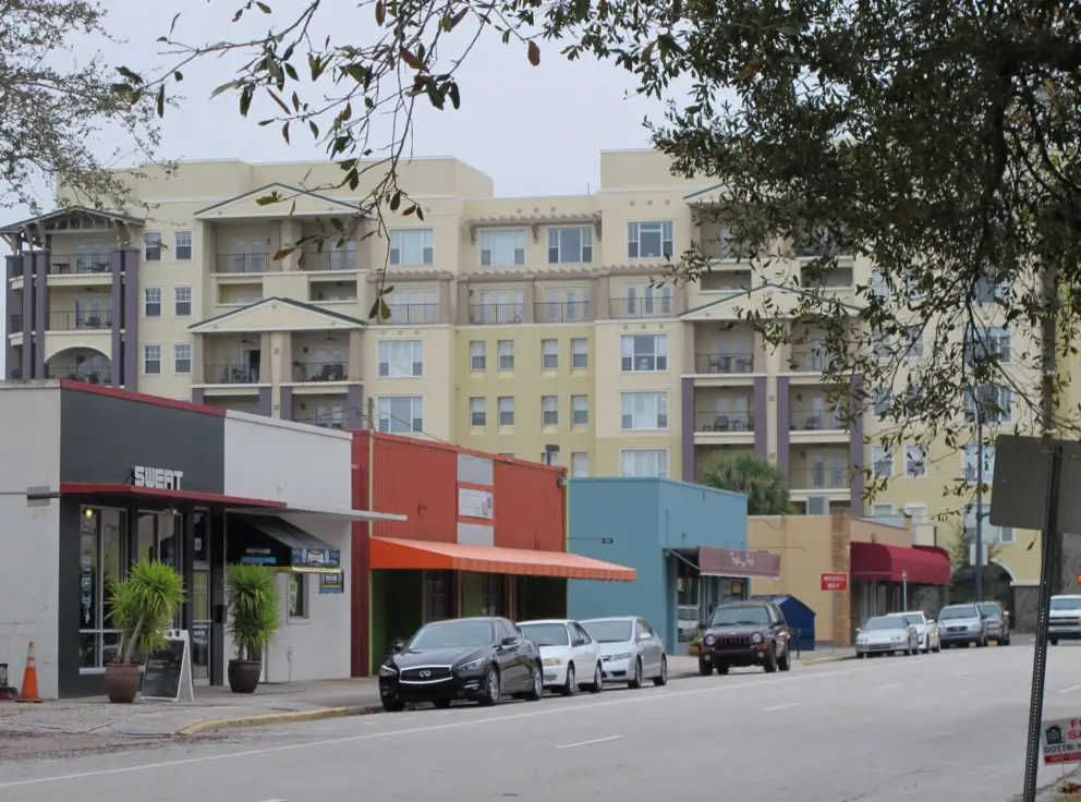 Strip mall on Smith St, with highrise behind.