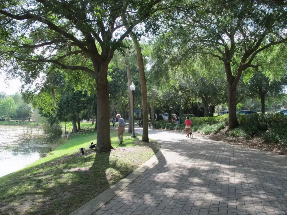 People taking an evening stroll at Lake Lily Park.