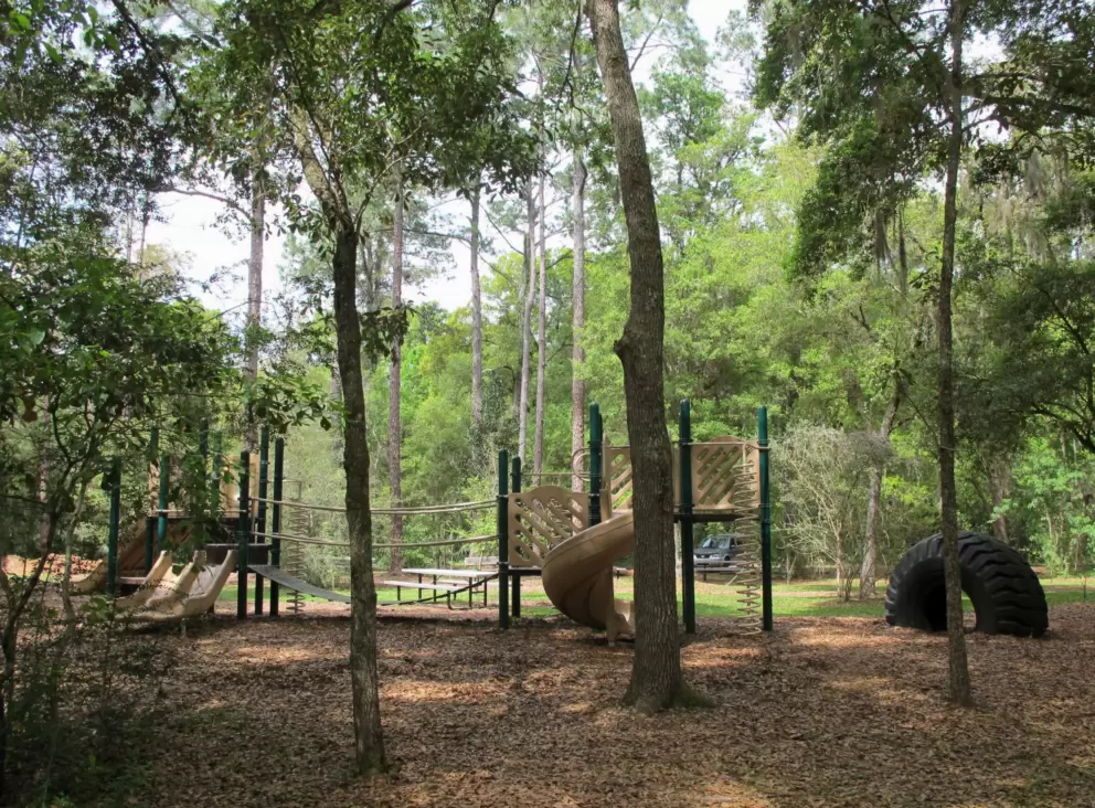 Shady playground with tire to crawl under!