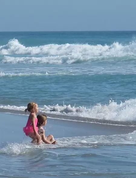 Little girls playing at the shore.