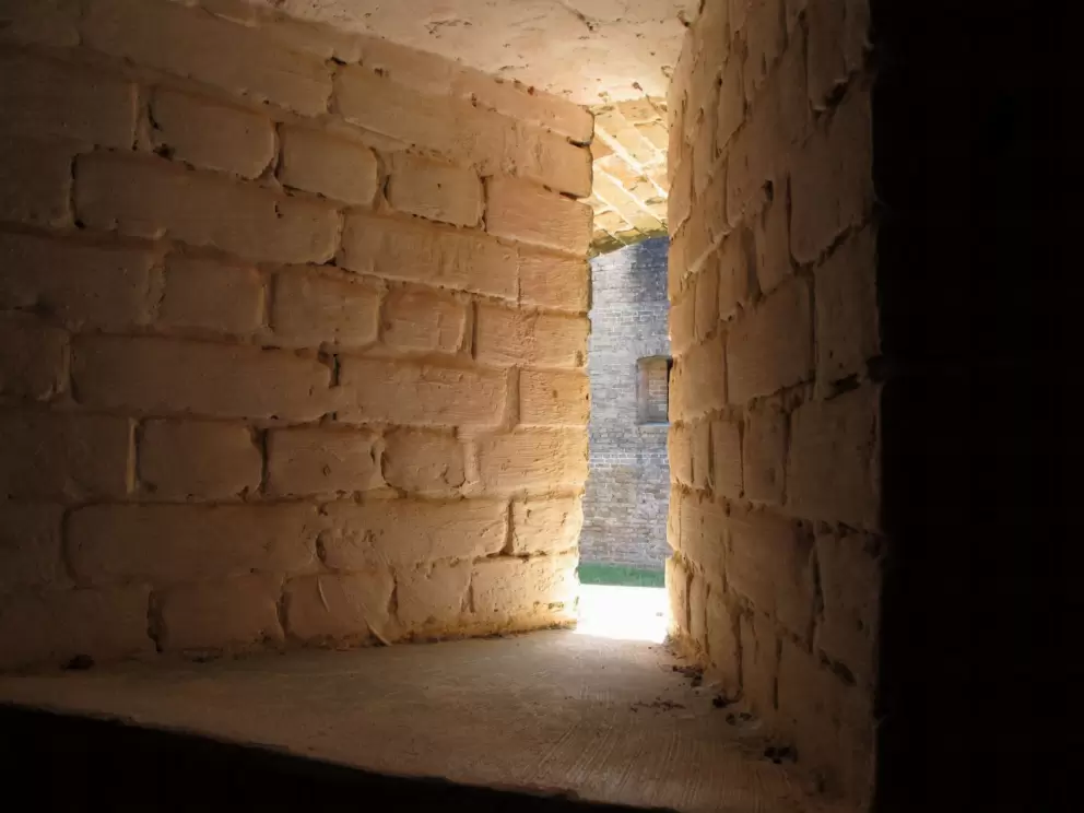 Peering through the slit where guns were fired.