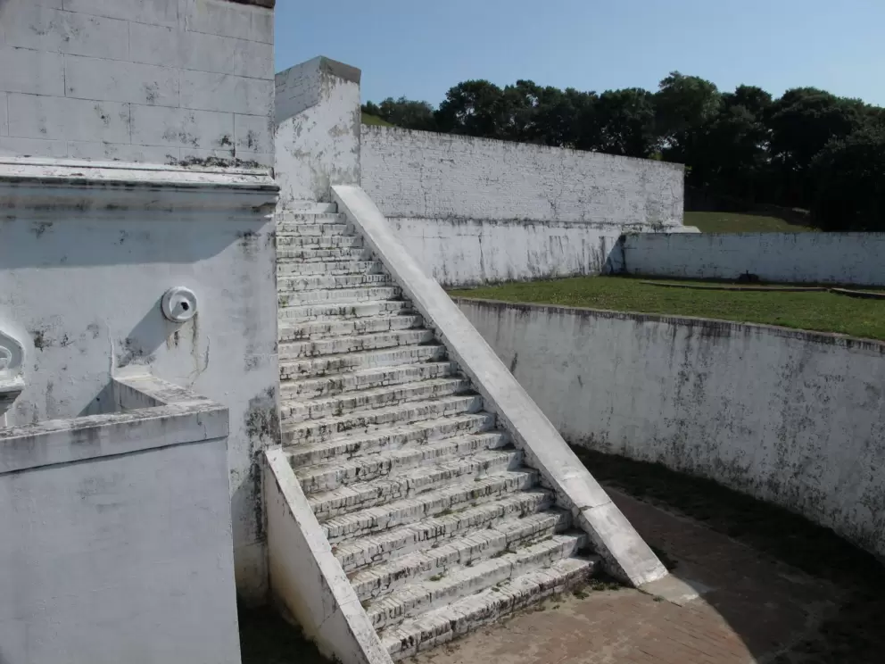 Climb the white stairs of the Spanish fort!