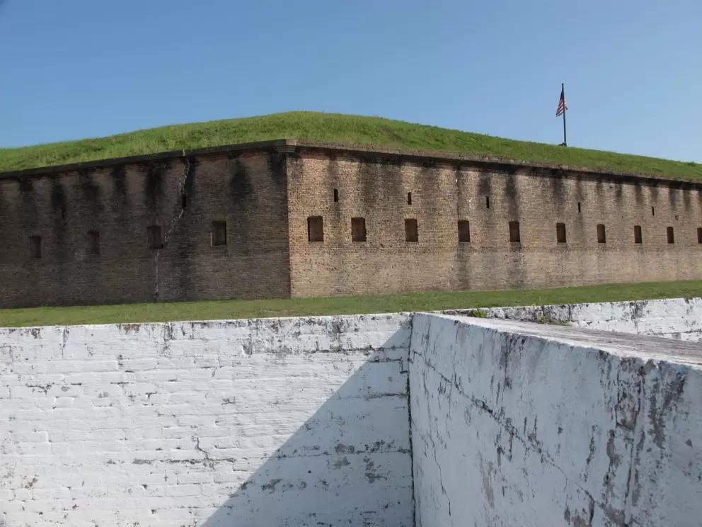 White wall of Spanish fort, with main fort behind.