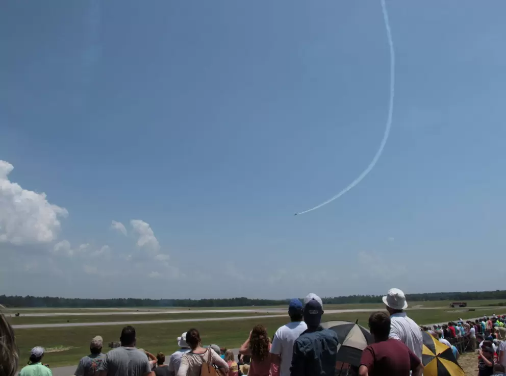 Onlookers watch the Blue Angels swoop down from the sky.