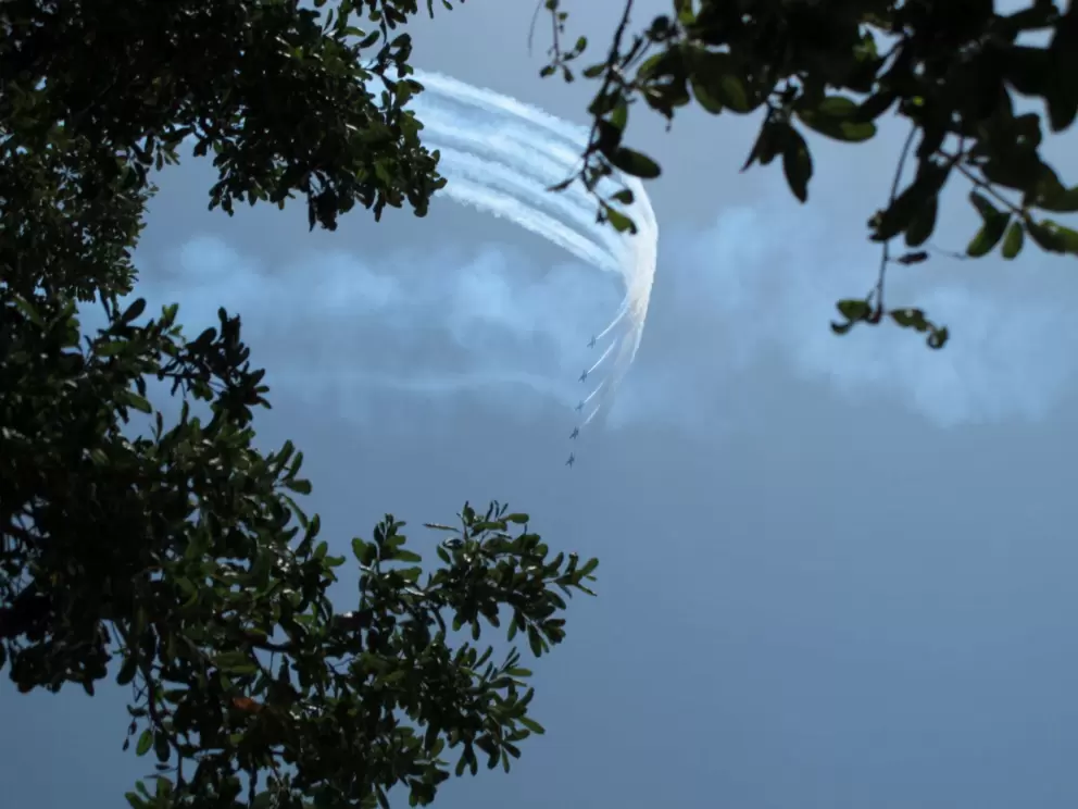 Five Blue Angels planes roar by.