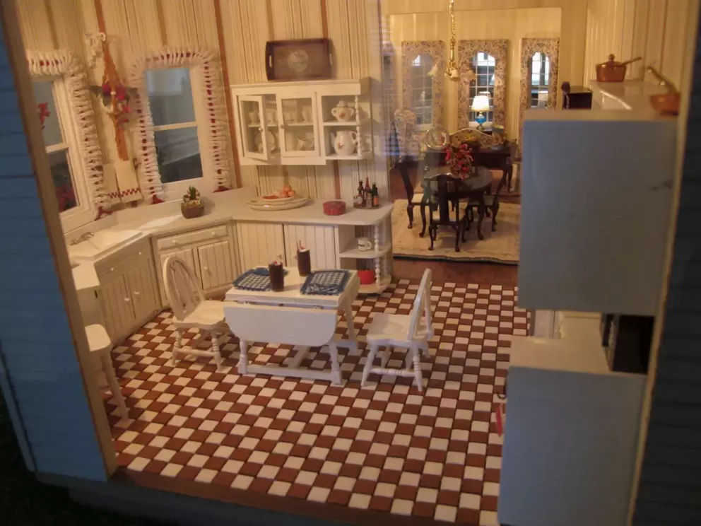 Doll house kitchen with checkered floor.