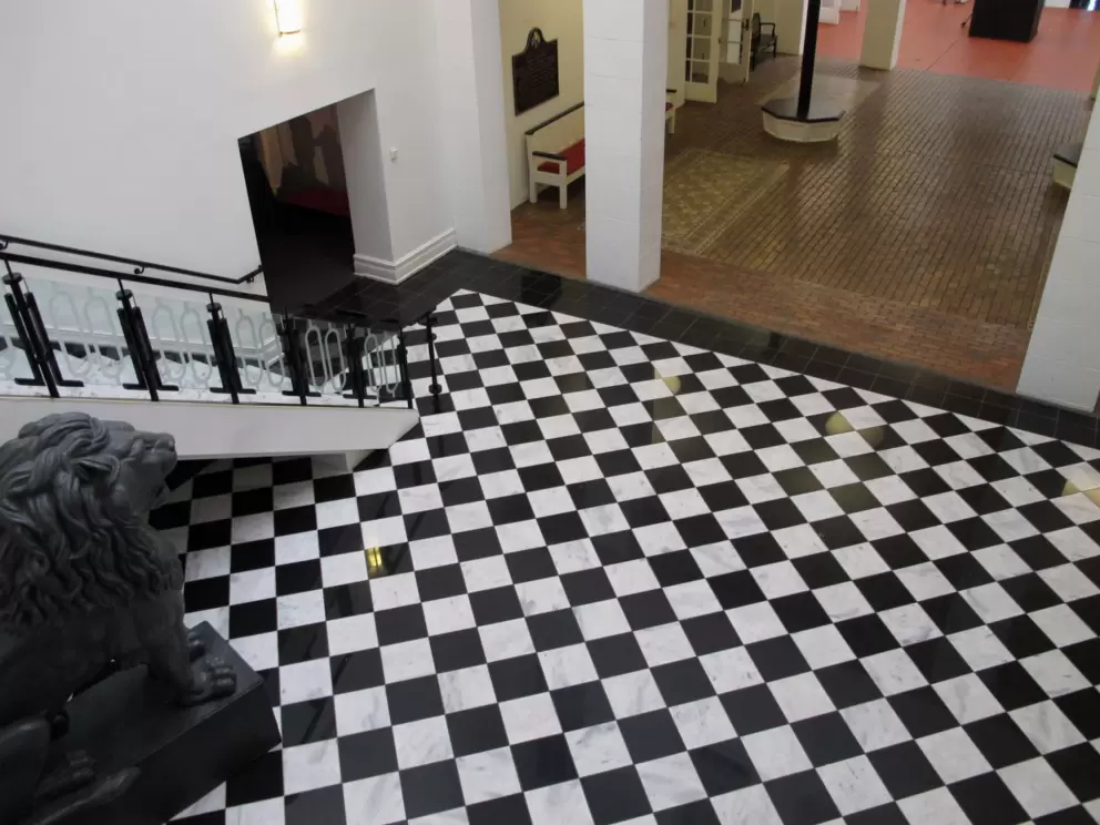 Black and white checkered floor and lion statue in the lobby.