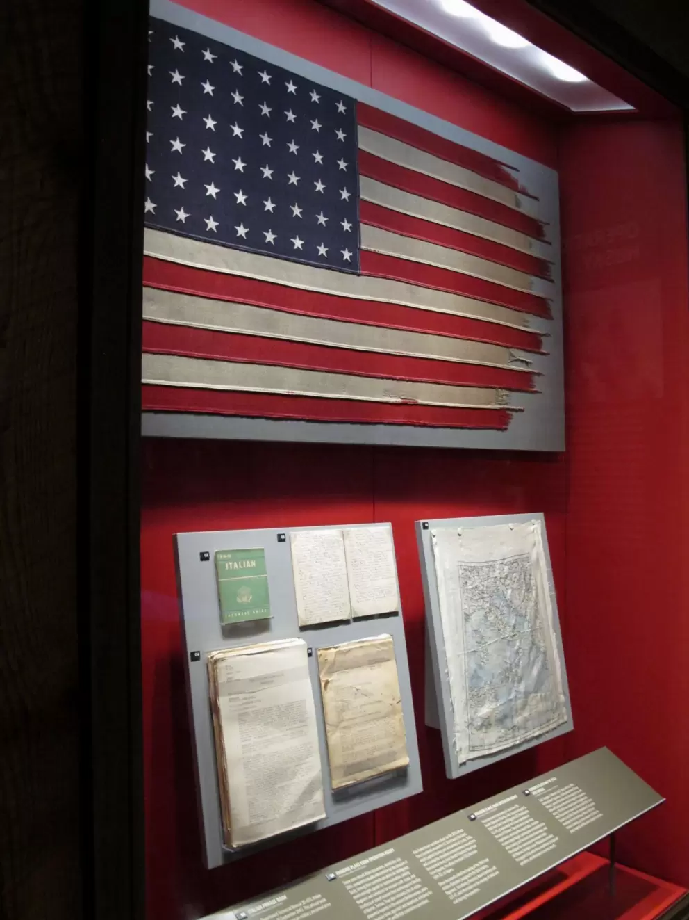 US flag, Italian phrasebook, and diary of the Sicily invasion.