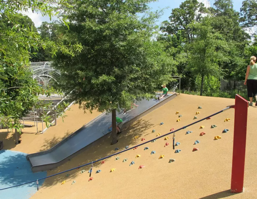 Rock-climbing holds and rope with handles in the pit area.