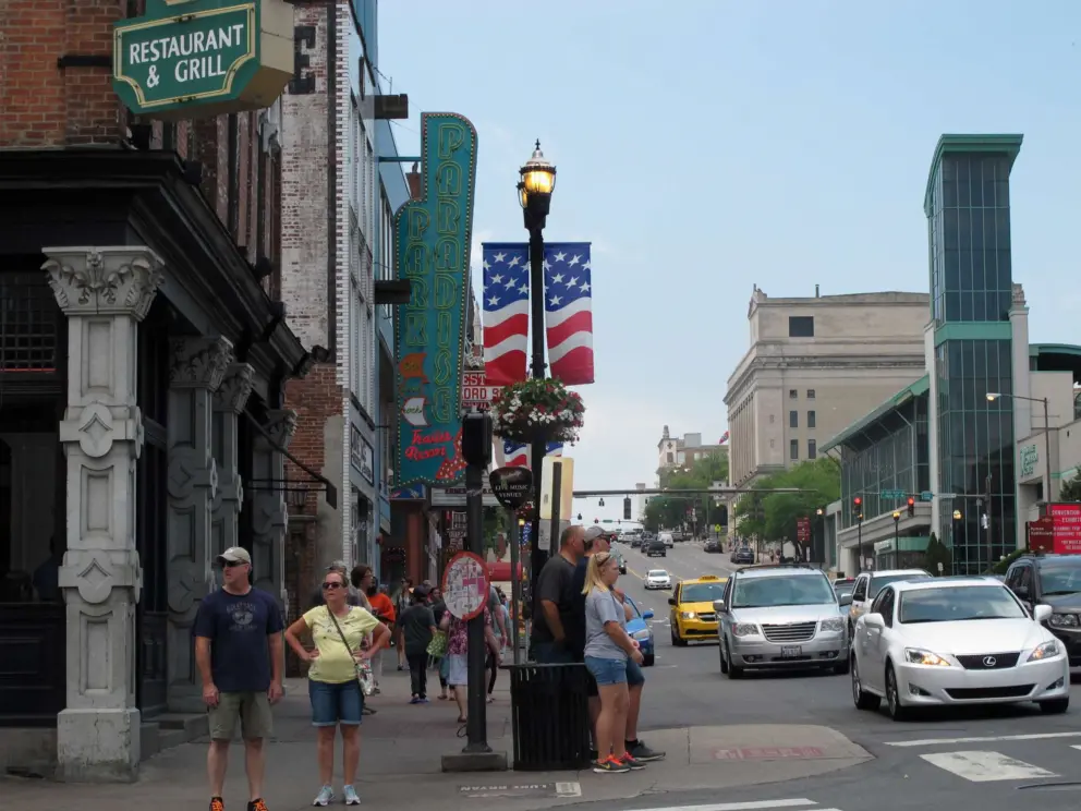 Visitors walk along Broadway at midday.