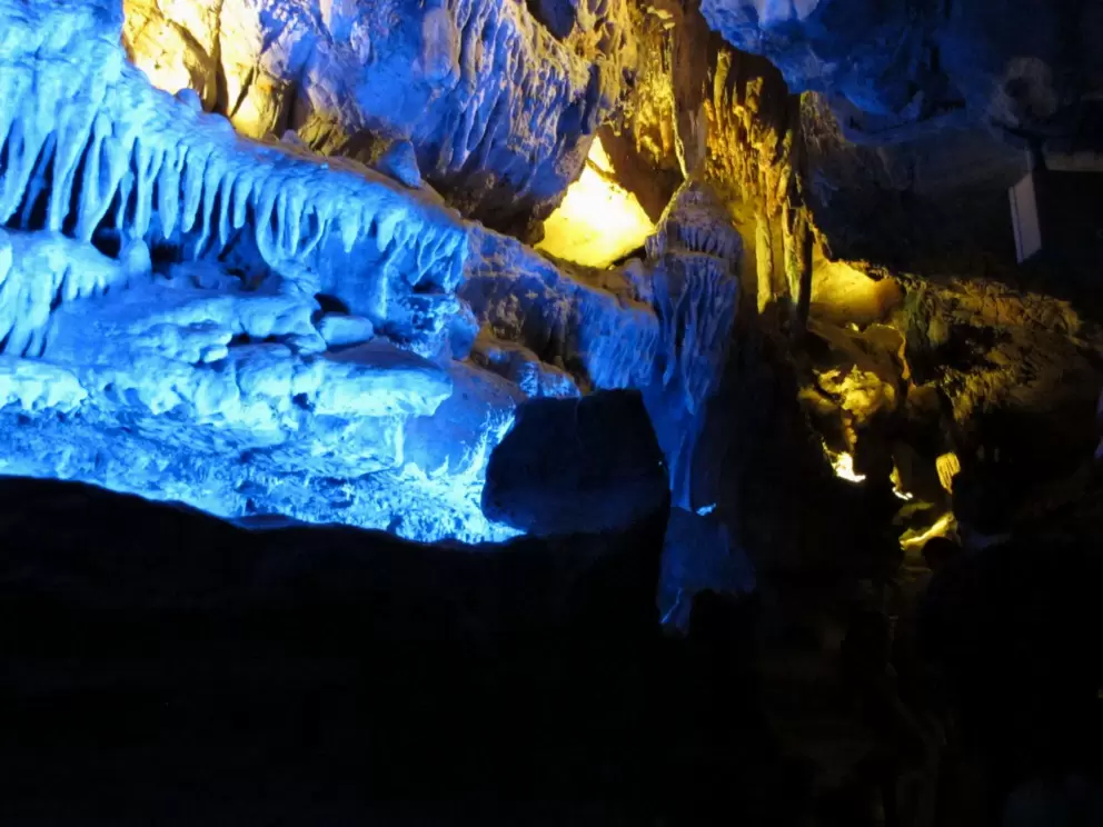 Blue lighting on cave formations.