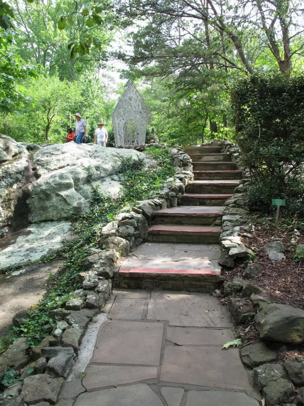 Stairs to a little white ironwork house.