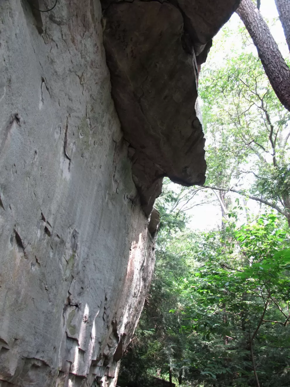 Looking up at a rock formation.
