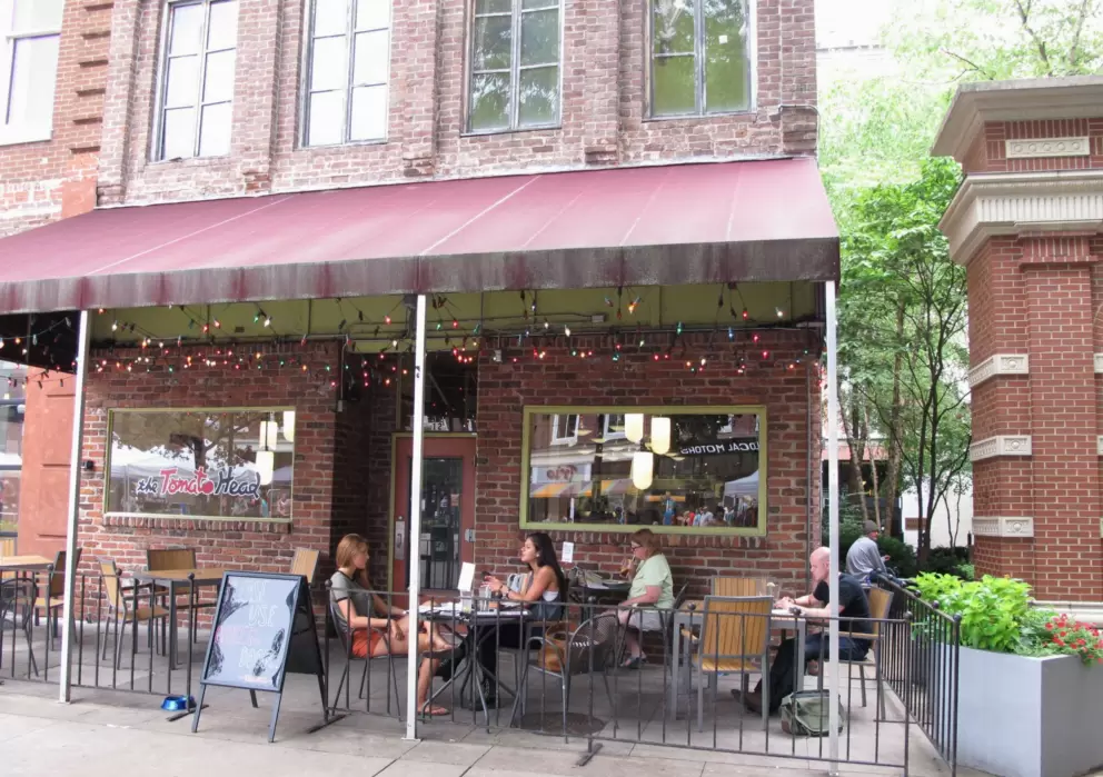 Sitting outside at a sidewalk cafe.