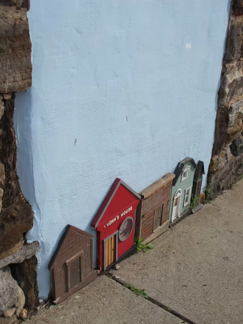 Tiny houses that decorate a building on Woodfin Street.
