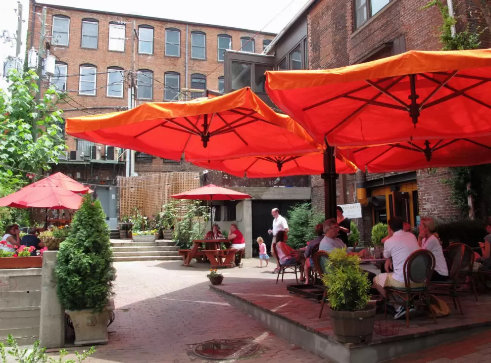 Orange umbrellas in the courtyard of Creperie Bouchon.