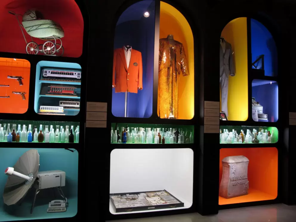 Orange Bowl jacket, Celia Cruz dress, satellite phone/ photo transmittal system used to report after Hurricane Andrew, and archaeology finds at the Sunlife Stadium site such as glass bottles.