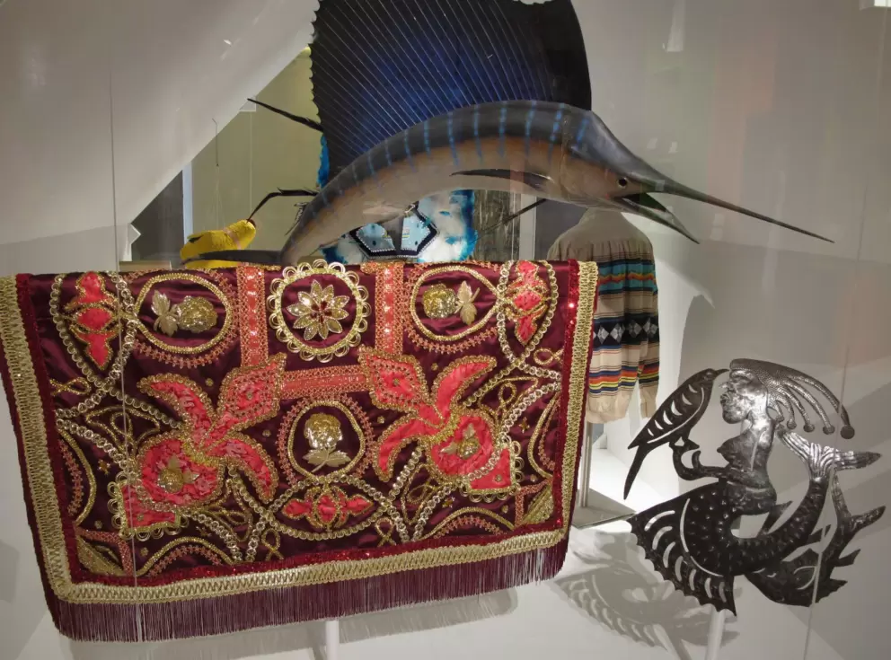 Haitian metal art of La Serine (a deity of the sea), marine taxidermy, and Orisha/Santeria textile.
