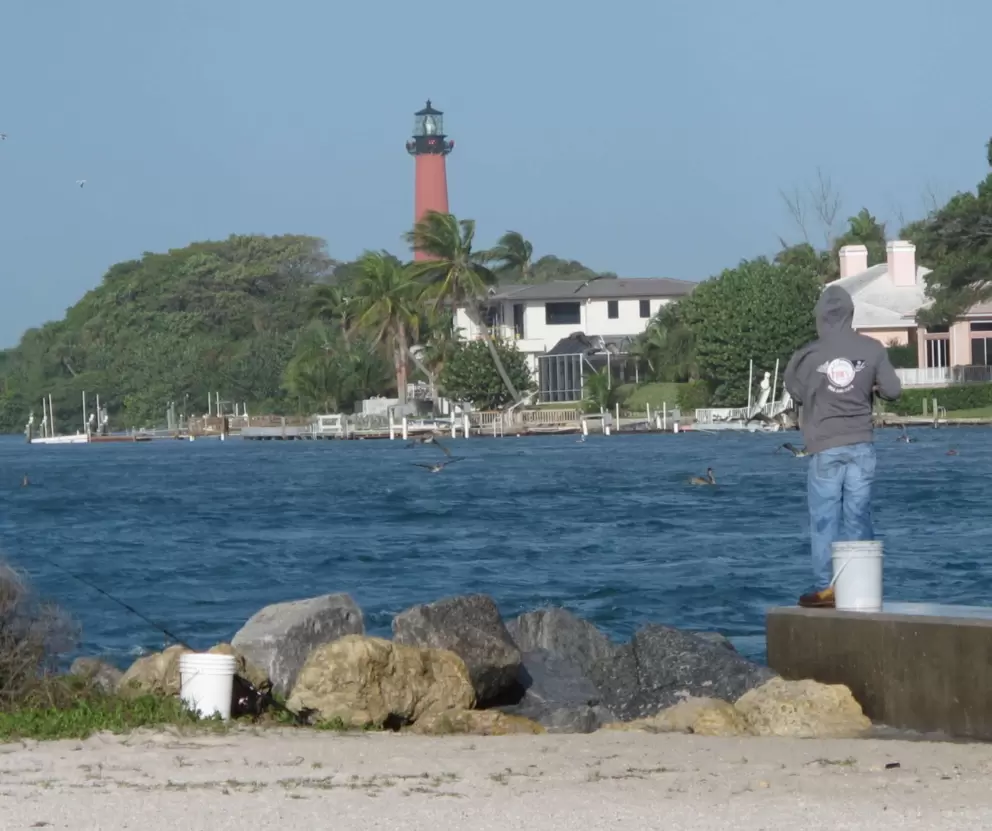 Fishing from the wall with a view of the lighthouse.