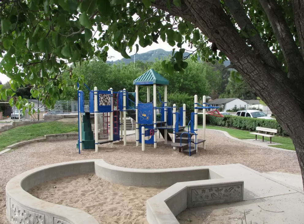 The playground with mountain views behind. 