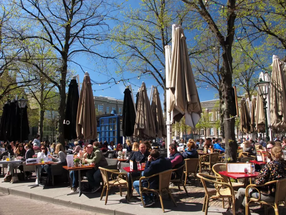 Many people gather for coffee at the square.