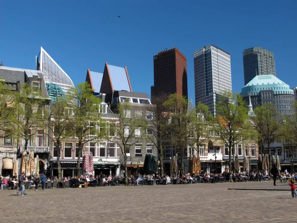 Modern buildings behind historic buildings.
