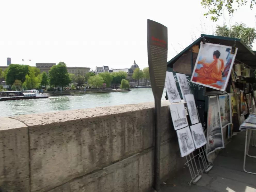 Painters sell their work above the Seine River, at Pont Neuf.
