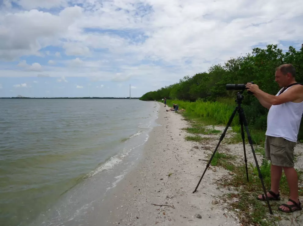 A man prepares to take a photo of the rocket launch.