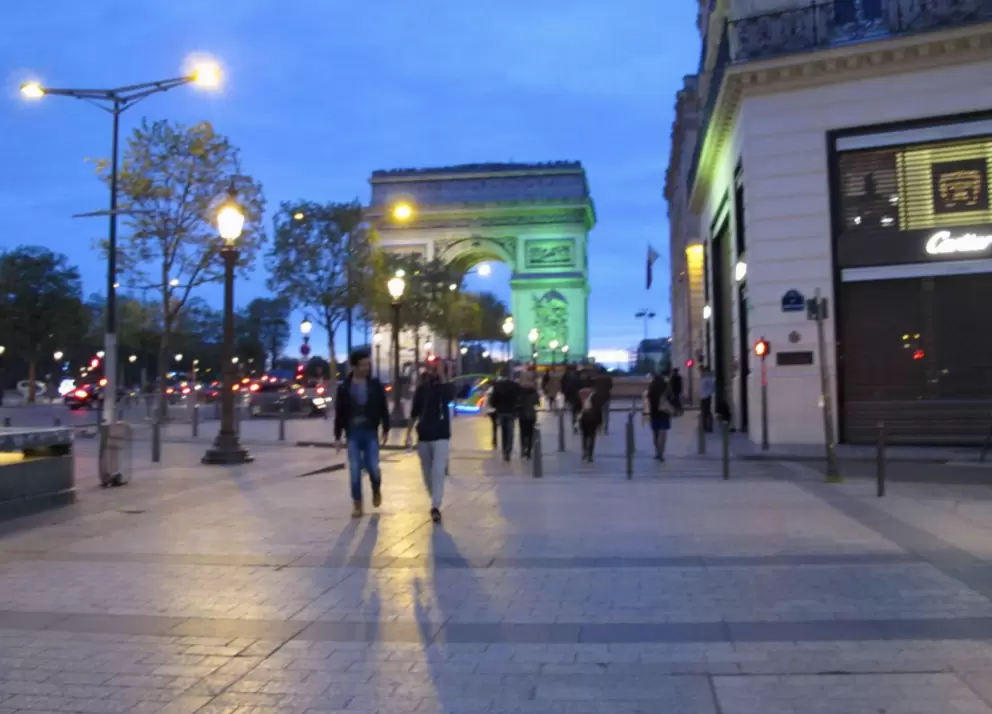 The lit-up Arc de Triomphe, at the northern end of the Champs-Elysee.
