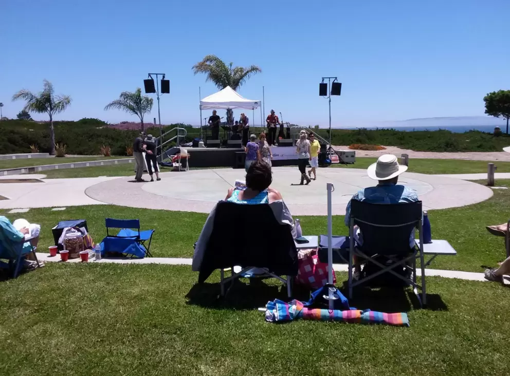 People dance in front of the amphitheater at the Sunday afternoon summer concerts.
