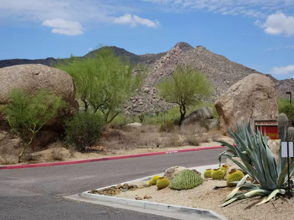 Views of mountains and a large boulder, as you leave the parking lot.