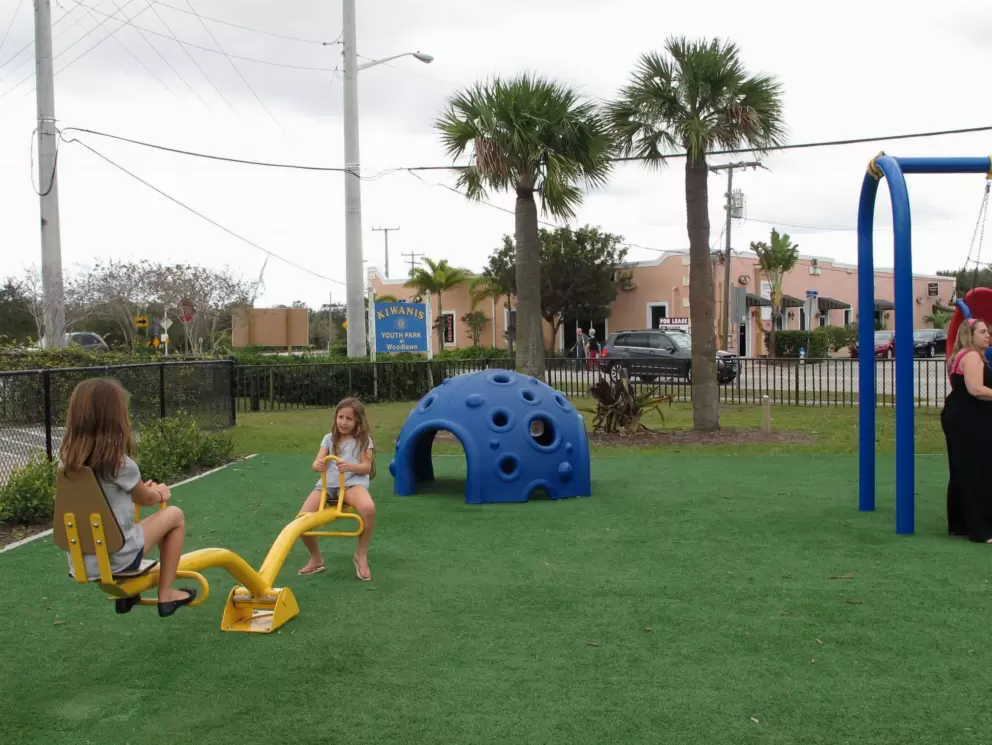 Girls play on the seesaw.