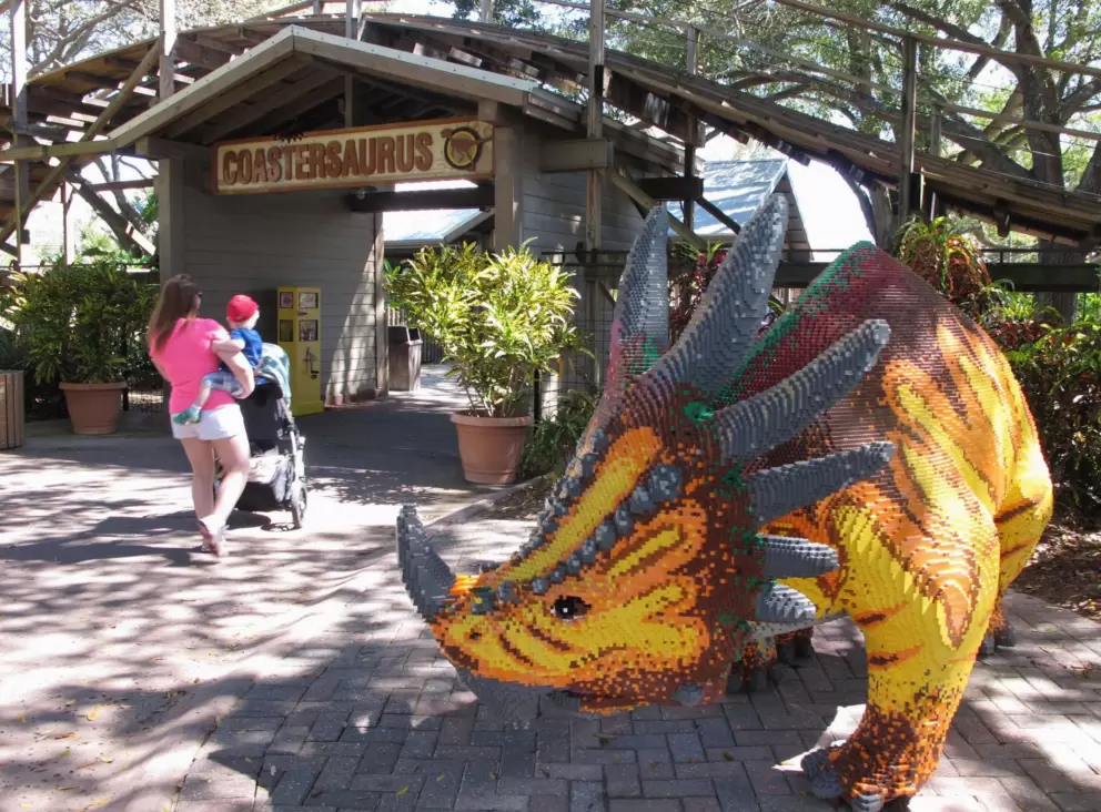 A lego dinosaur in front of Coastersaurus.