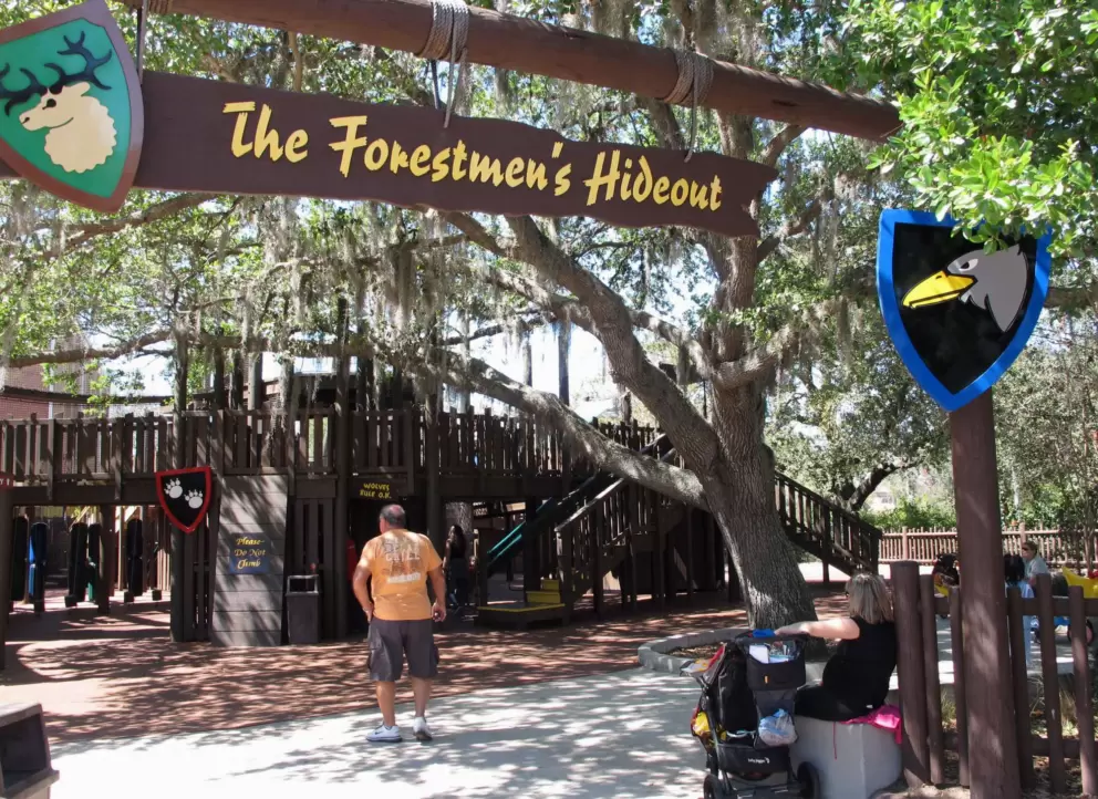Forestmen's Hideout, a wooden playground under trees.