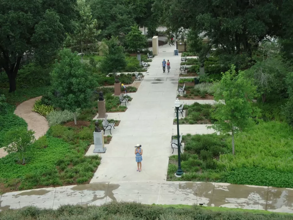 A couple walks among the statues.