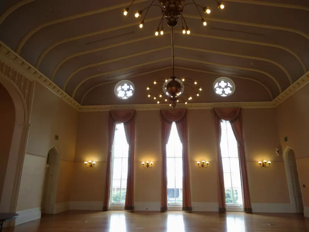 The ballroom with its high ceiling and elegant curtains.