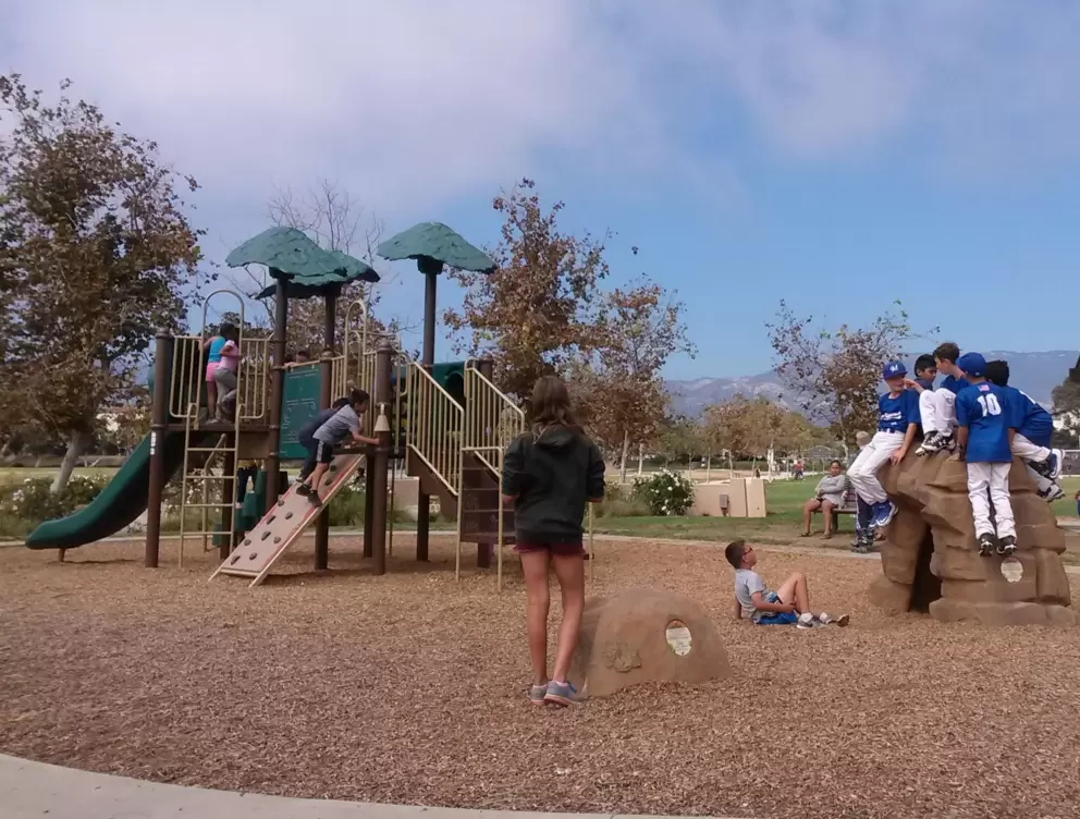 Kids playing on the playground on a weekend day.