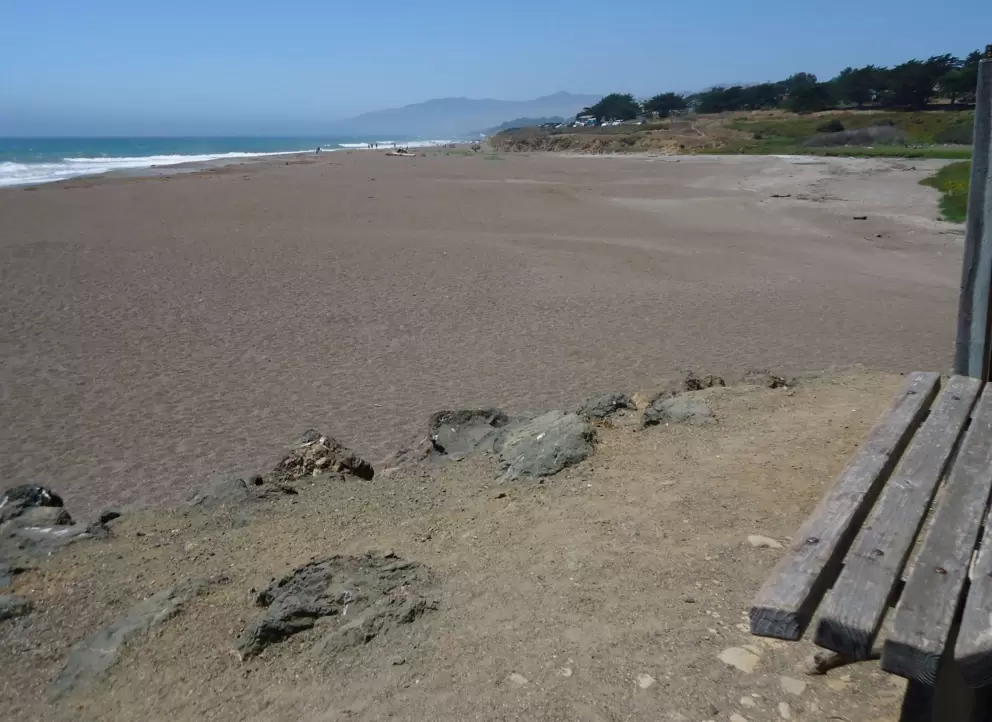 Bench over the barren beach.