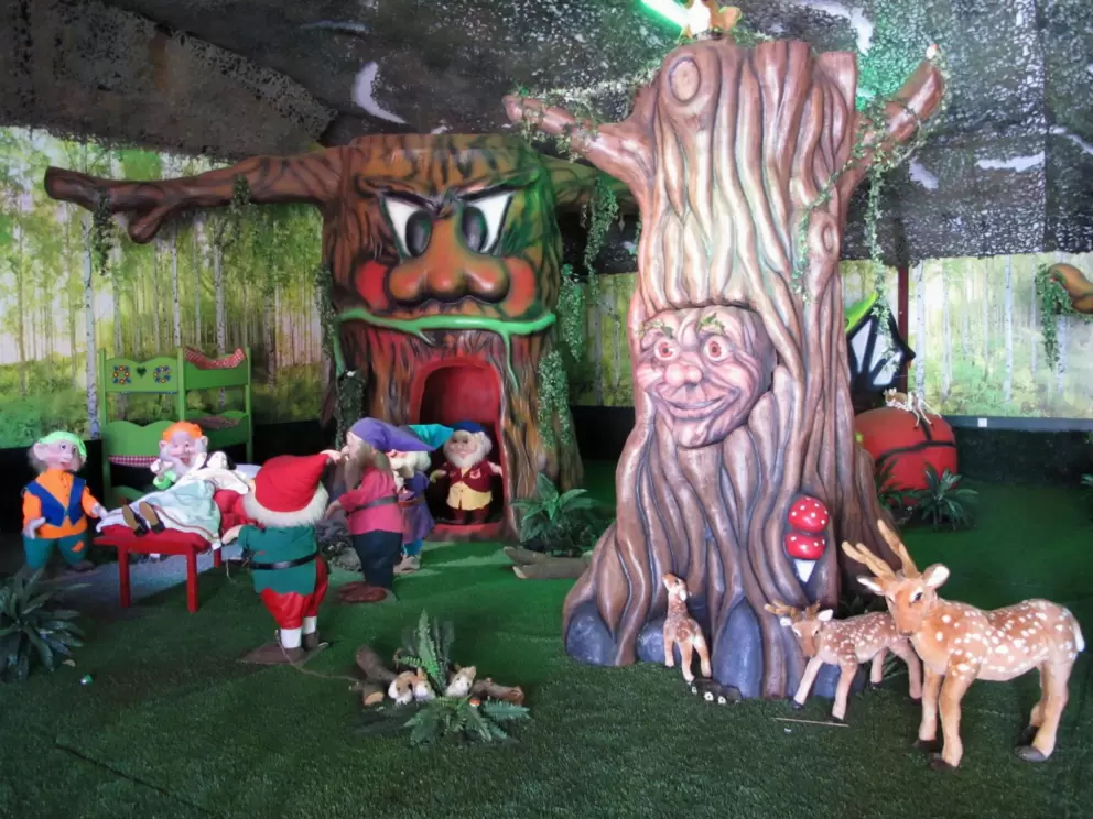 Indoor play area with forest theme.
