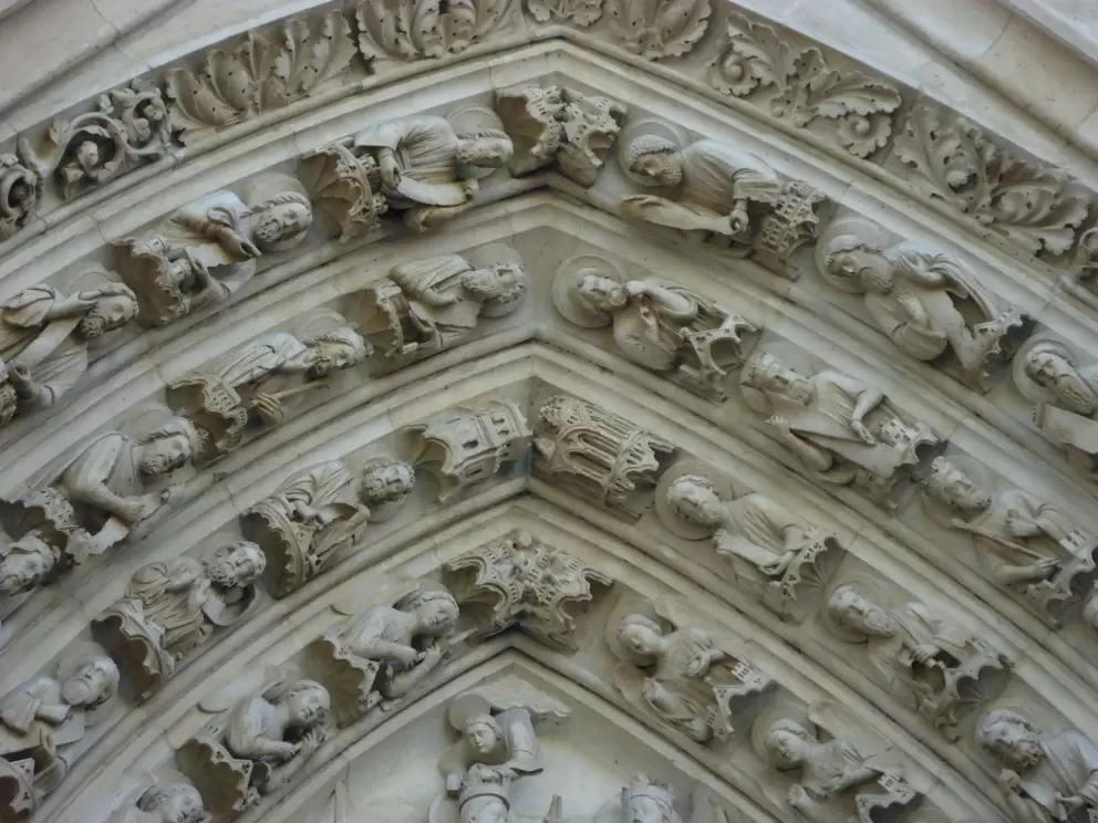 Engravings of saints above the doorway to Notre Dame.
