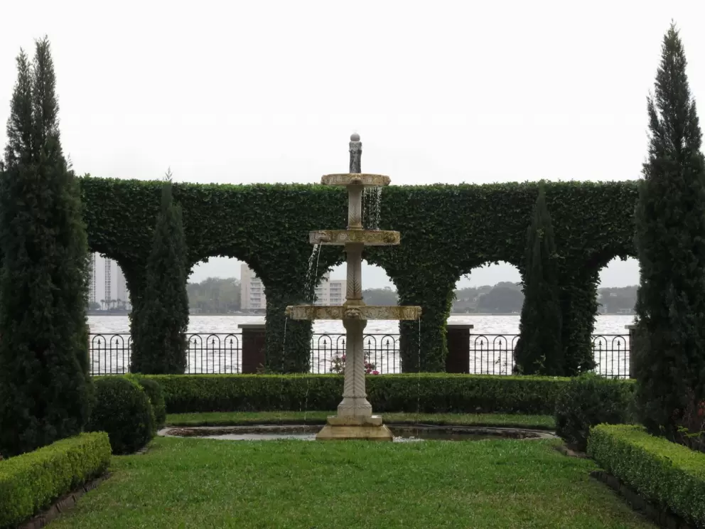 Looking through the hedge arches at the water.