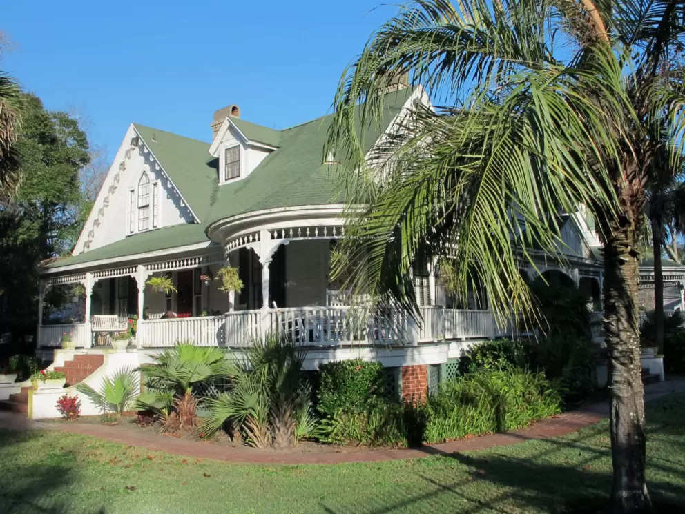 Historical home with sweet wrap-around balcony.