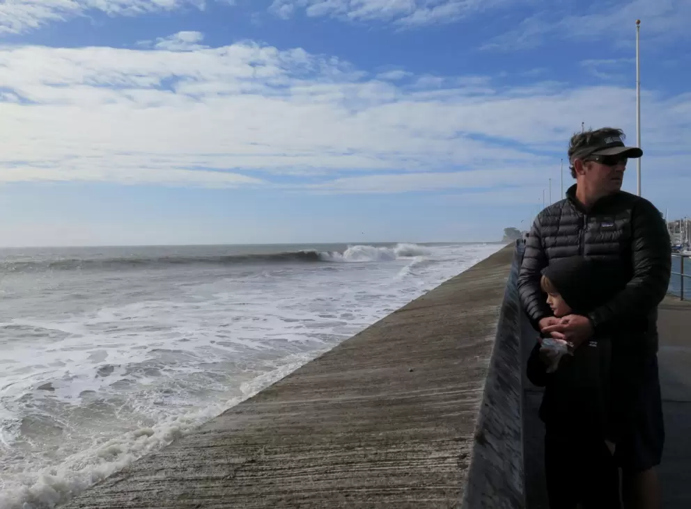A dad and son watch the water.