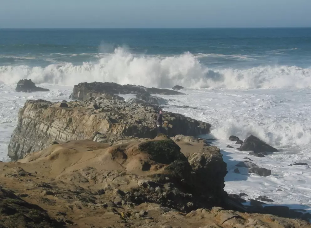 "Check out these waves!" a viewer yells above the roar. Sea mist obscures the view.