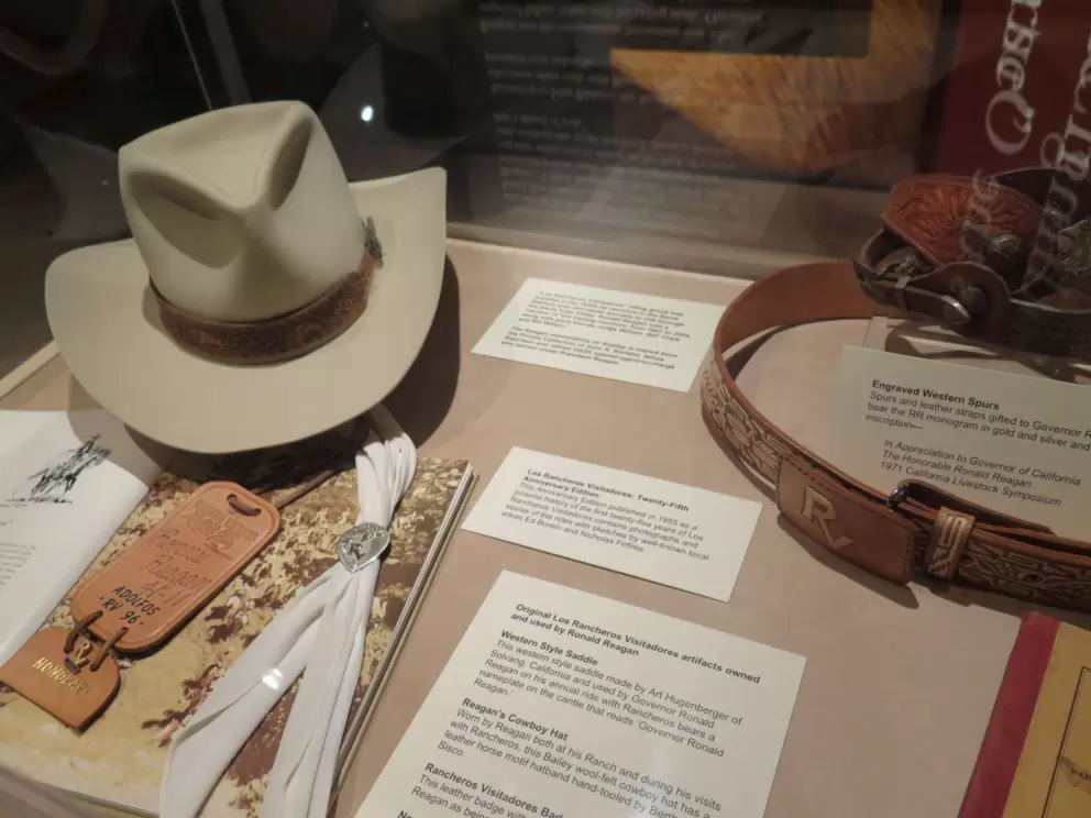 Reagan's cowboy hat, spurs, and leather straps.