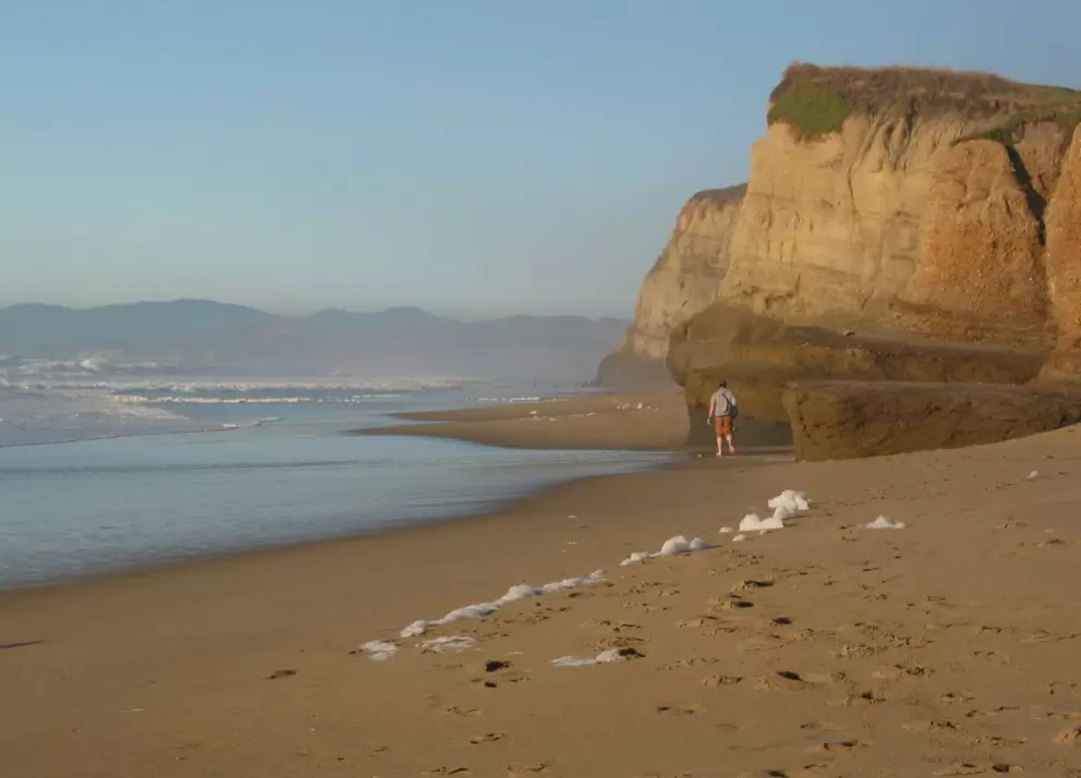Fluffy clouds of sea-foam churned up by the raging swell at Pomponio Beach.