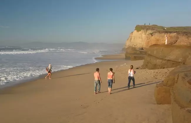 College students and families gather at Pomponio Beach.