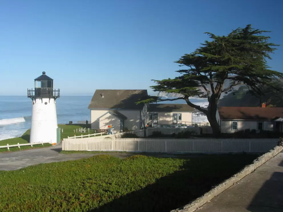 The Point Montara Lighthouse, and youth hostel, shaded by a Monterey cypress. 