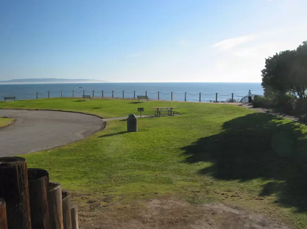 Sloping lawn and ocean views, picnic tables and benches strategically placed.
