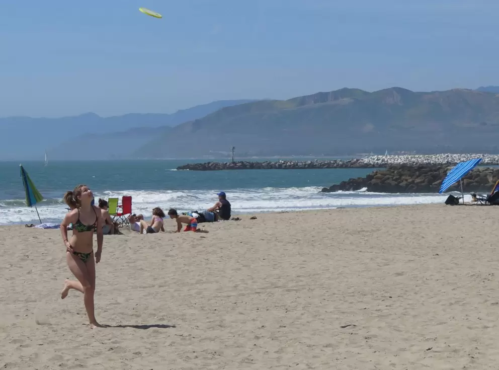 Playing frisbee in the nice sand.